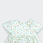 Children's dress with colorful star pattern on a light gray background