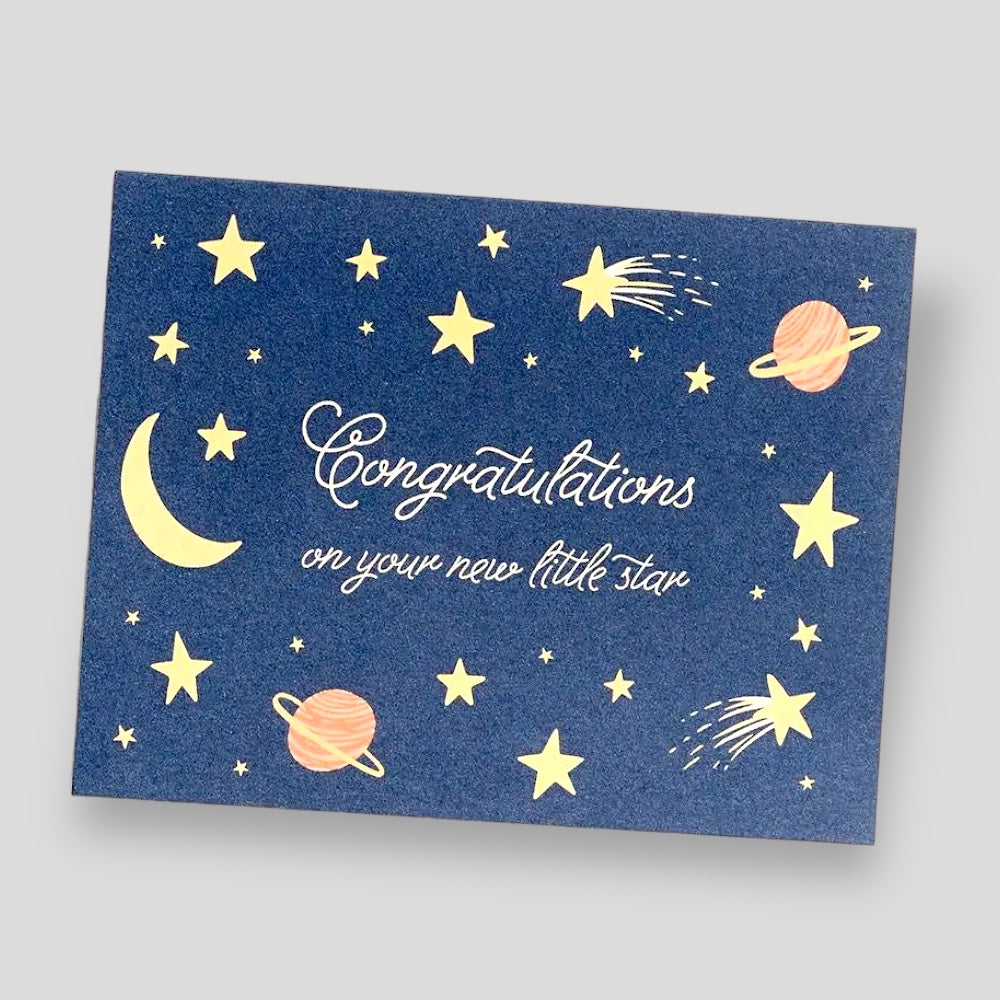 Greeting Card: Congratulations on Your New Little Star. Blue card with yellow stars and planet illustrations.