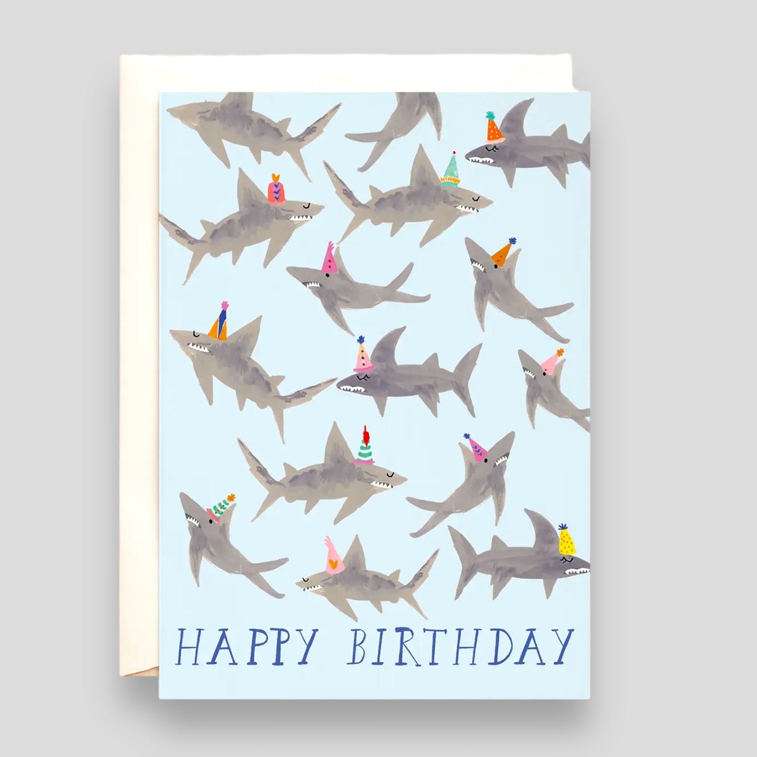 Greeting Card: Sharks Happy Birthday. Blue card with illustrations of sharks wearing birthday hats.