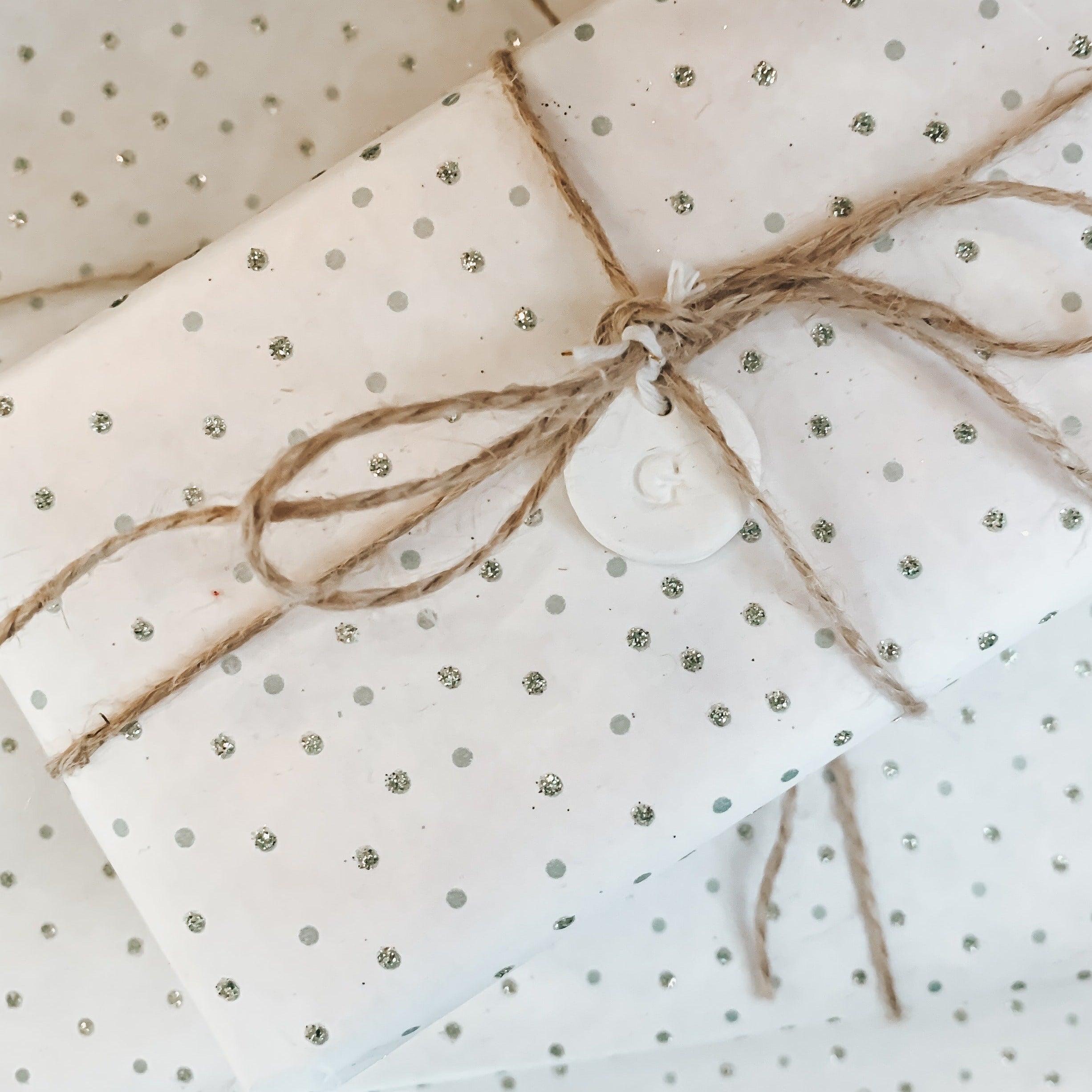 Sample picture of polka dot tissue wrap with a twine bow.