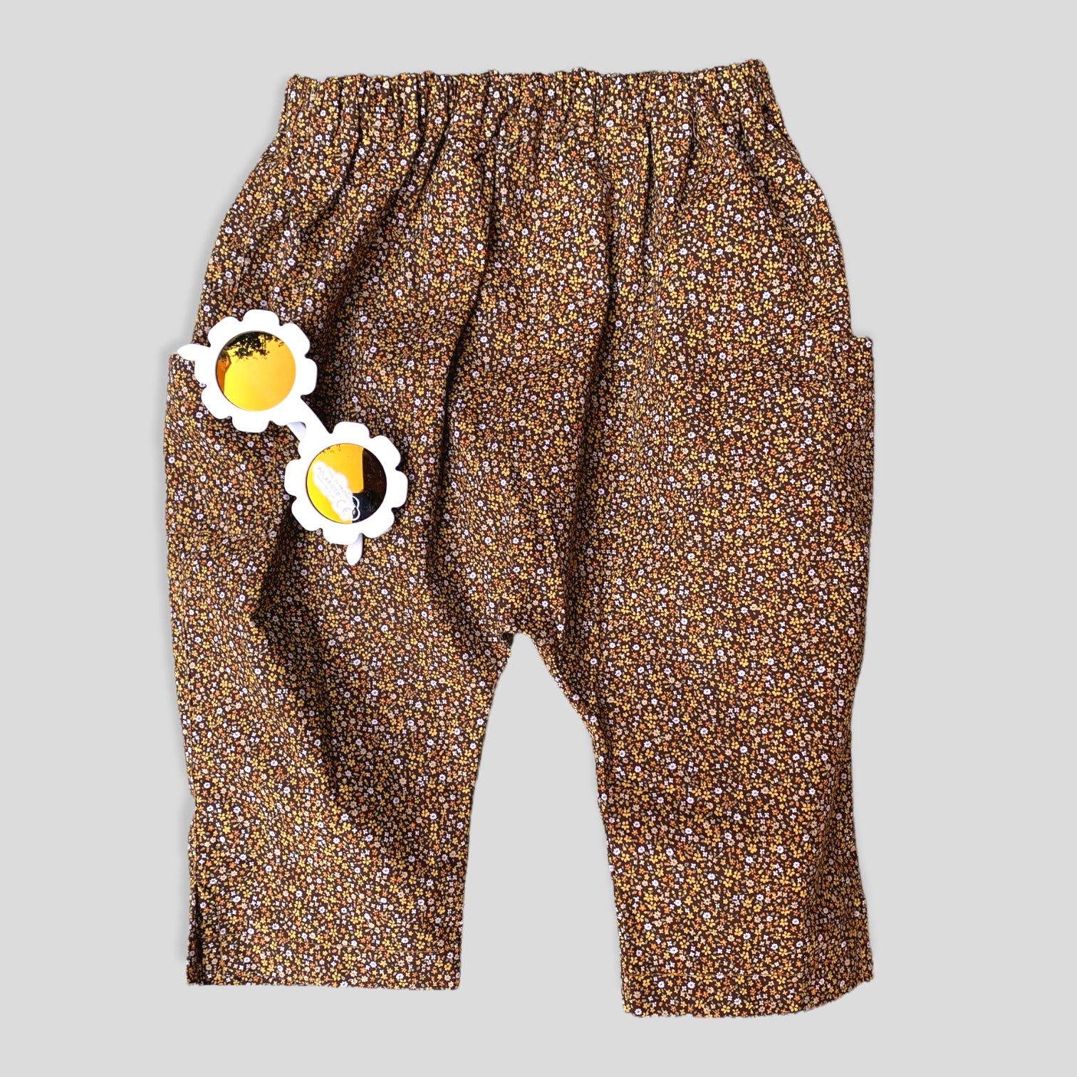 Cotton Golden Brown and Yellow Petite Fleur Harem Pants for Babies and Kids. Curated look with White Daisy Sunglasses (not included).