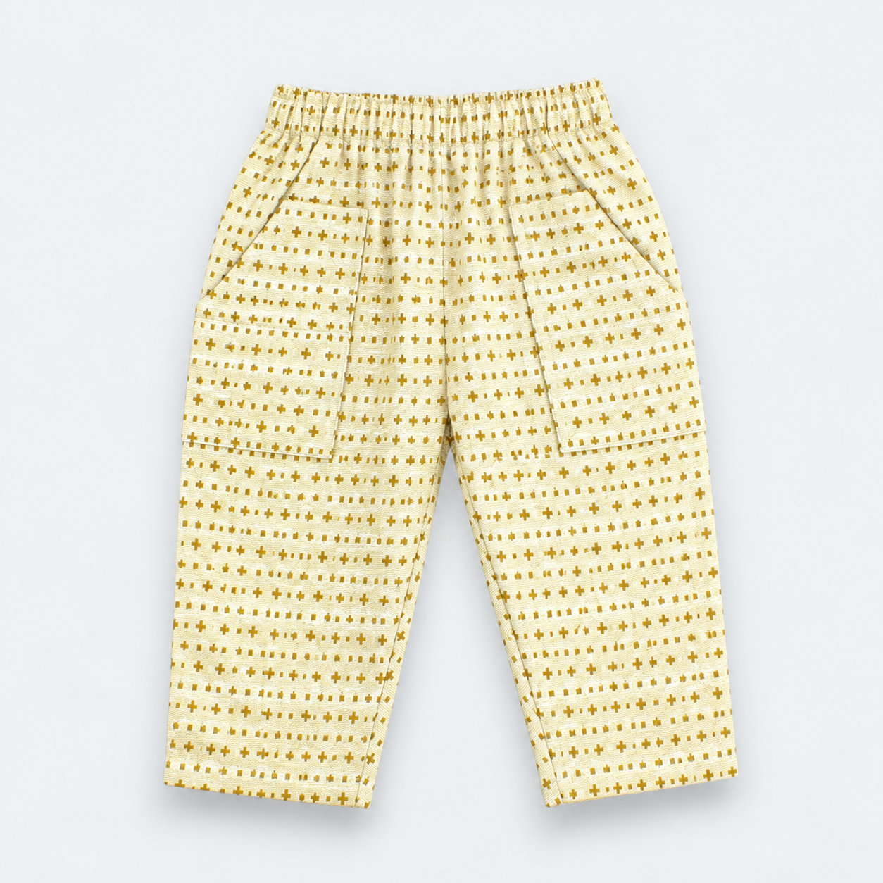 Yellow and white patterned pants with an elastic waistband and side pockets, laid flat on a light gray background.