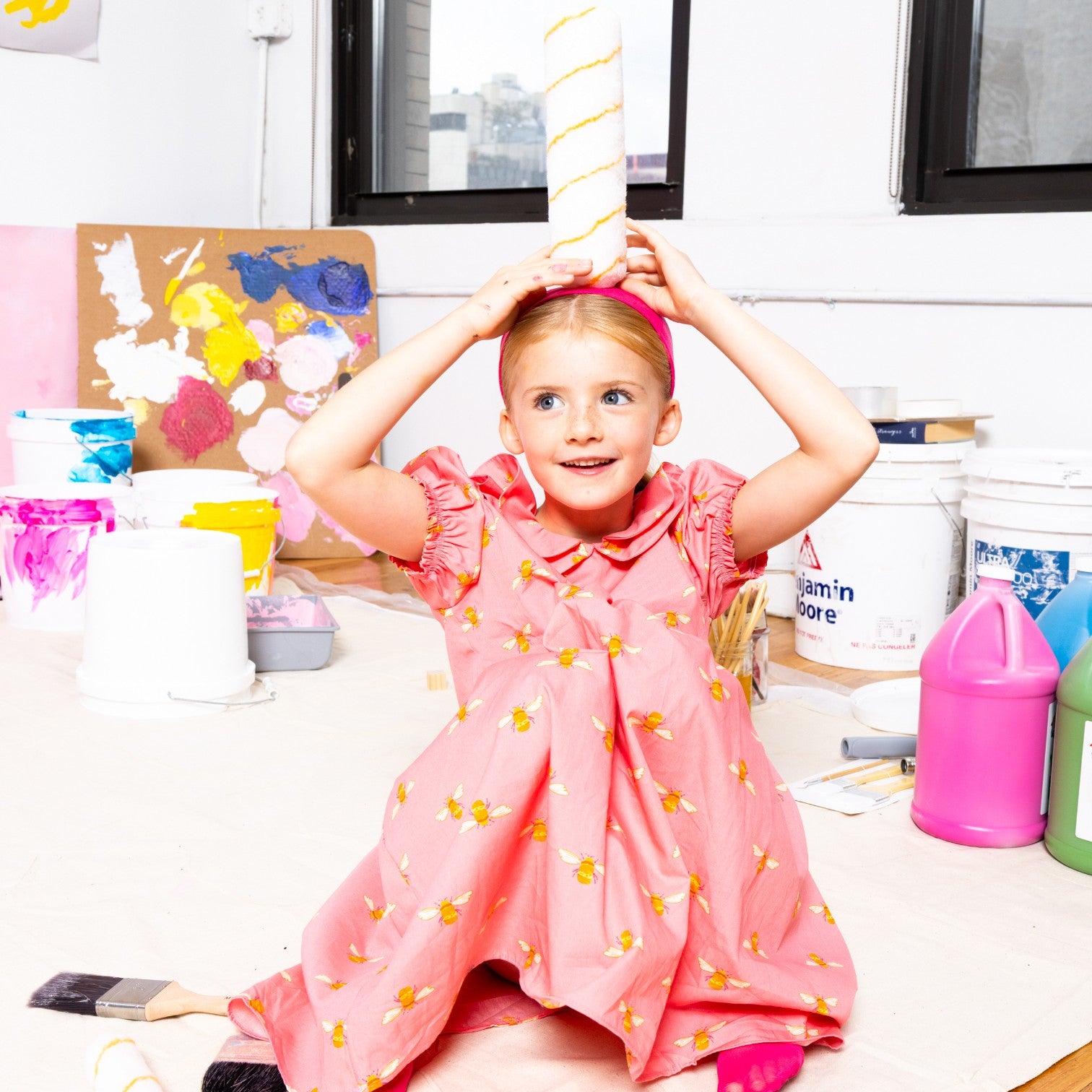 Girl wearing Little Moony Honey Bee Petal Dress, handmade pink cotton dress designed in NYC