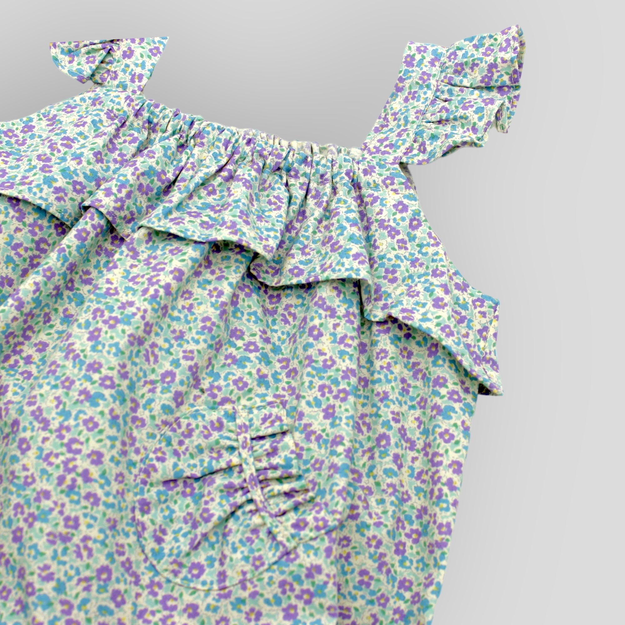 Blue Cotton Petite Fleur Bubble Romper for Baby Girls. Detail view of front pocket.