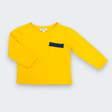 A bright yellow long-sleeve children's top with a small dark navy blue chest pocket accent, displayed flat against a light gray background.