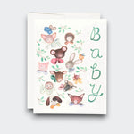 A white baby greeting card with “Baby” written vertically in green, surrounded by watercolor woodland animals including a rabbit, mouse, hedgehog, fox, and puppy. A white envelope sits behind it.