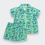 Children's outfit with shirt and shorts featuring a crocodile pattern on a light blue background
