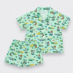 A two-piece alligator set featuring a short-sleeve button-up shirt and matching shorts in a light mint green color with a colorful all-over dinosaur print, displayed on a light gray background.