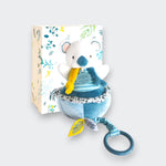 Doudou et Compagnie Yoka the Koala Musical Pull Toy – soft plush koala in teal and white with yellow pull cord and ring, shown with botanical gift box