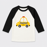 A children's raglan long-sleeve shirt with black sleeves and a white body, featuring a graphic of a yellow NYC taxi on the front.