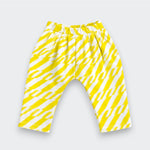 A pair of Little Moony children's pants featuring a bold yellow and white diagonal zigzag pattern, displayed flat against a light gray background.