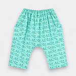 A pair of baby pants in mint green with a repeating black dragonfly pattern, featuring an elastic waistband and a wide leg design.