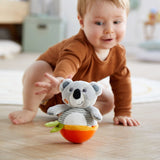 Baby playing with HABA Koala Roly Poly toy during tummy time on a soft play mat