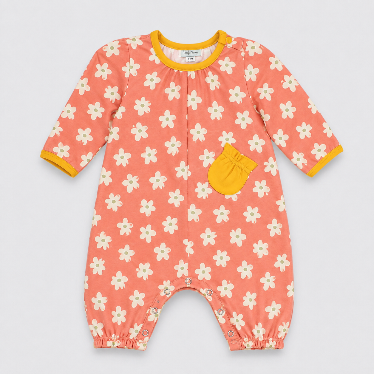 A baby long-sleeve romper in a coral pink color, featuring a white daisy floral pattern, a yellow pocket, and yellow trim on the collar and cuffs, laid flat on a light gray background.