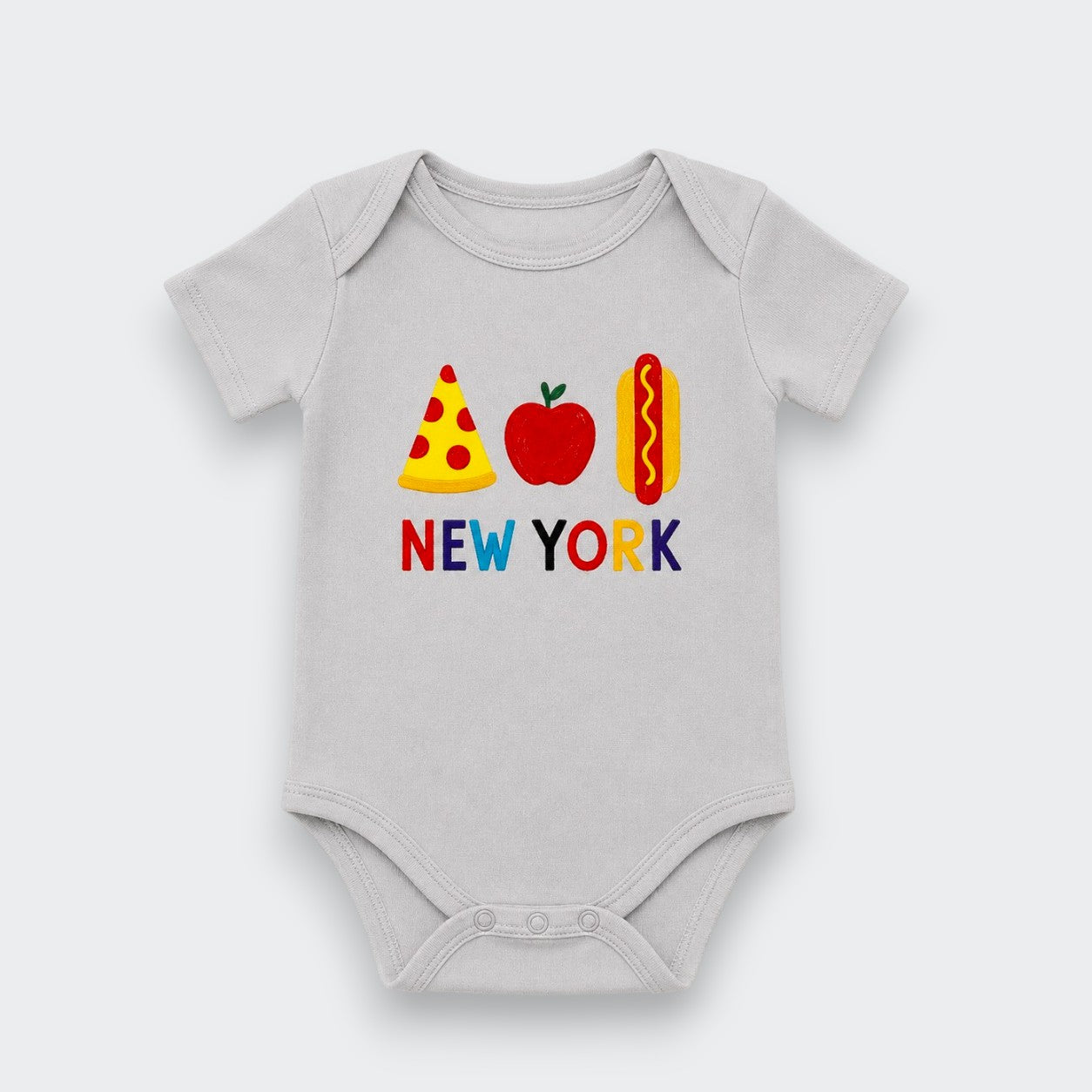 A light gray baby bodysuit featuring a colorful graphic of a pizza slice, red apple, hot dog, and the text 'NEW YORK' in multicolored letters, displayed on a clean light gray background.