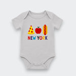 A light gray baby bodysuit featuring a colorful graphic of a pizza slice, red apple, hot dog, and the text 'NEW YORK' in multicolored letters, displayed on a clean light gray background.