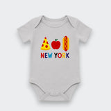 A light gray baby bodysuit featuring a colorful graphic of a pizza slice, red apple, hot dog, and the text 'NEW YORK' in multicolored letters, displayed on a clean light gray background.