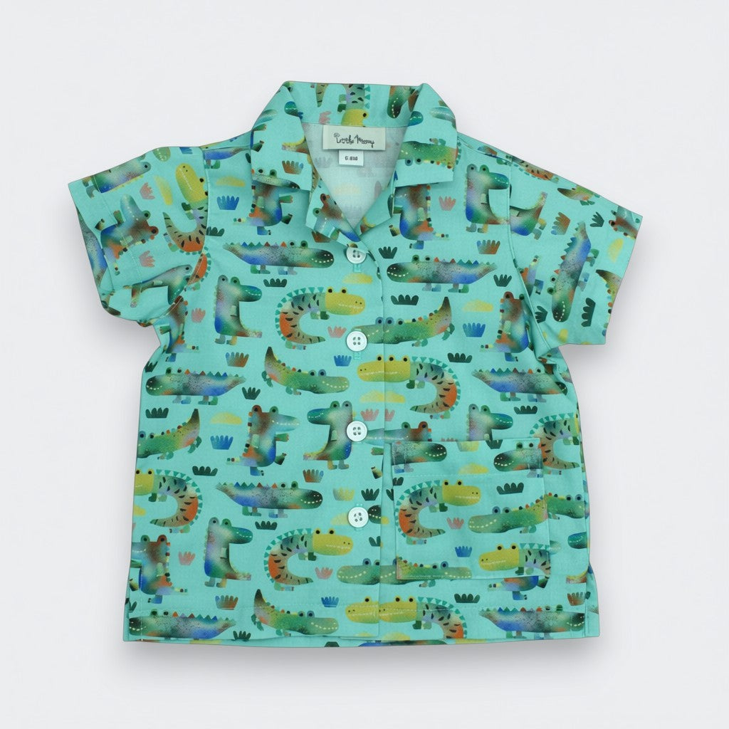 Children's shirt with alligator pattern on a light blue background