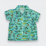 Children's shirt with alligator pattern on a light blue background