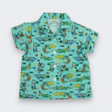 Children's shirt with alligator pattern on a light blue background
