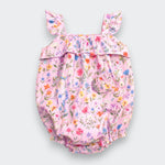 A pink floral baby bloomers romper with ruffled shoulder straps and a small front pocket, shown flat on a light gray background.
