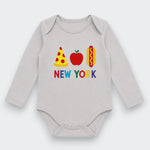 A light gray long-sleeve baby bodysuit with a colorful graphic on the chest featuring a slice of pizza, an apple, a hot dog, and the text 'NEW YORK' in multicolored letters.