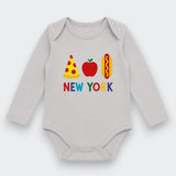 A light gray long-sleeve baby bodysuit with a colorful graphic on the chest featuring a slice of pizza, an apple, a hot dog, and the text 'NEW YORK' in multicolored letters.