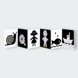 Book cover with a black flower and fish illustration and text about touch and black and white.  My First Black and White Book: Touch!  Pages view.