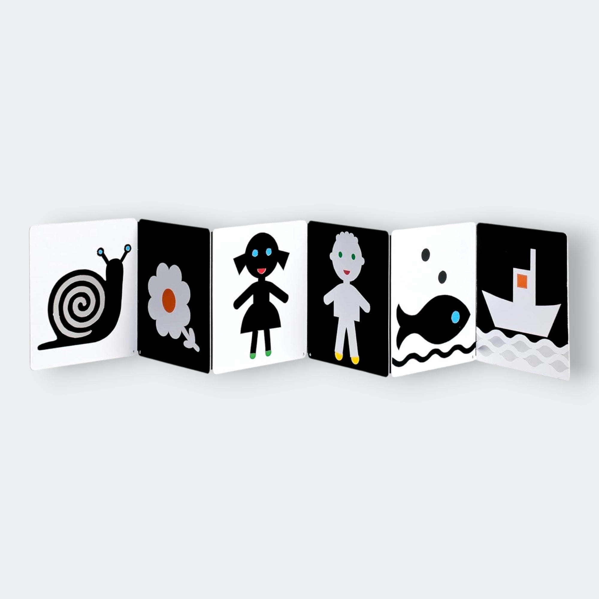 Book cover with a black flower and fish illustration and text about touch and black and white.  My First Black and White Book: Touch!  Pages view.