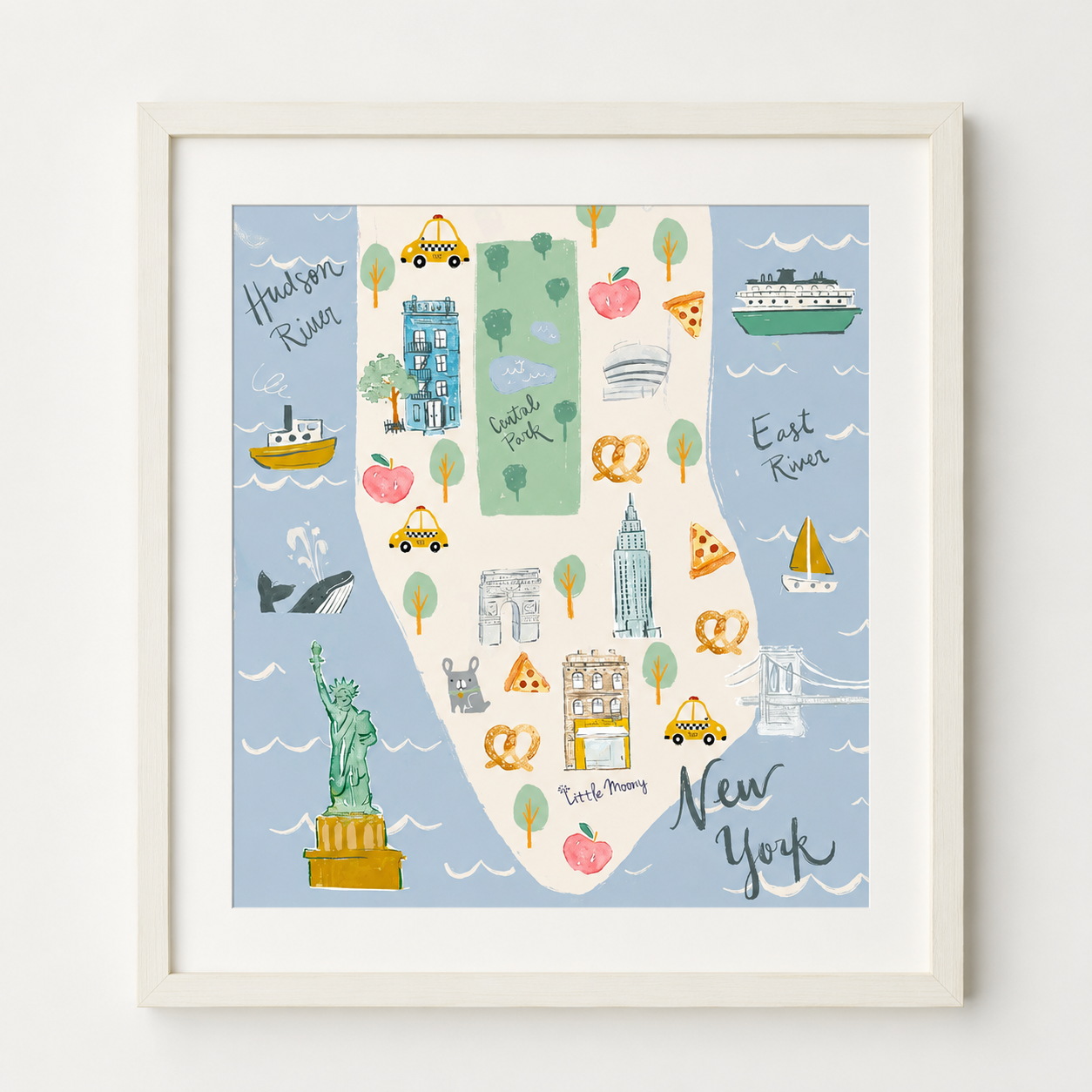 Framed New York City map art print featuring illustrated landmarks, taxis, pizza slices, and river sections on a light blue background, shown in a white frame against a white wall.