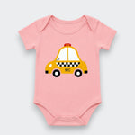 A light pink baby bodysuit featuring a cartoon graphic of a yellow NYC taxi with black and white checkered details, displayed on a light gray background.