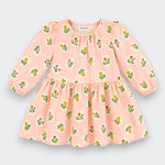 A pink long-sleeve baby dress with a floral print, featuring a gathered waist and elasticized cuffs, shown flat on a light gray background.