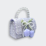 Little Moony Lily & Bow purple tweed purse with tulip details, pearl bow, and detachable gold chain for children. Side view.