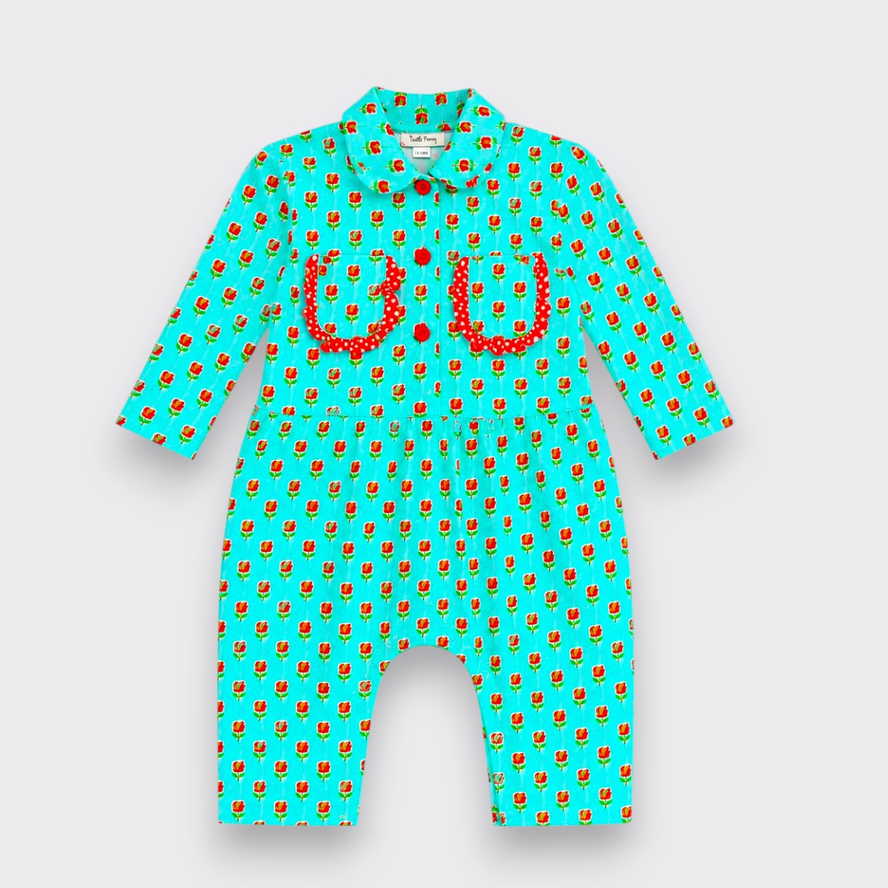 A baby long-sleeve romper in bright turquoise with a repeating red and yellow strawberry print, featuring two red polka-dot chest pockets and a red strawberry motif on the chest, shown on a light gray background.