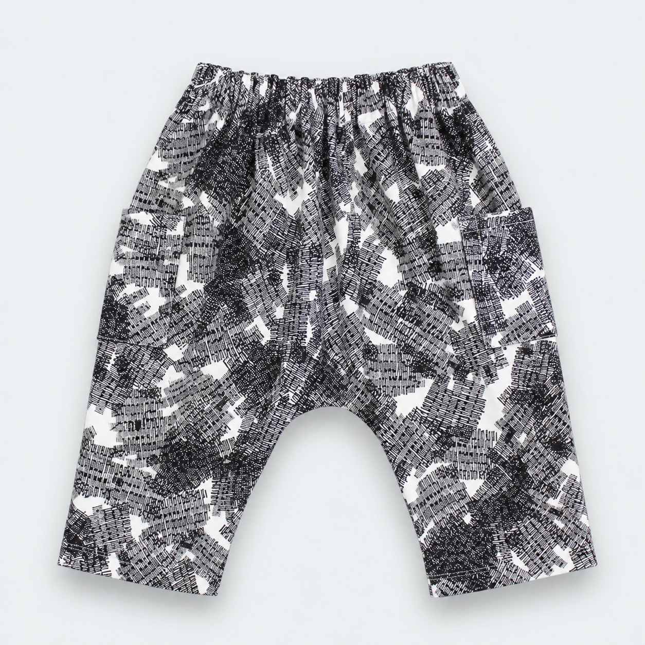 Black and white patterned harem pants with an elastic waistband, laid flat on a light gray background.