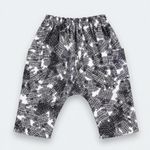 Black and white patterned harem pants with an elastic waistband, laid flat on a light gray background.