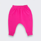 Bright pink baby jogger pants with an elastic waistband, side pockets, and cuffed ankles, shown flat on a light gray background.