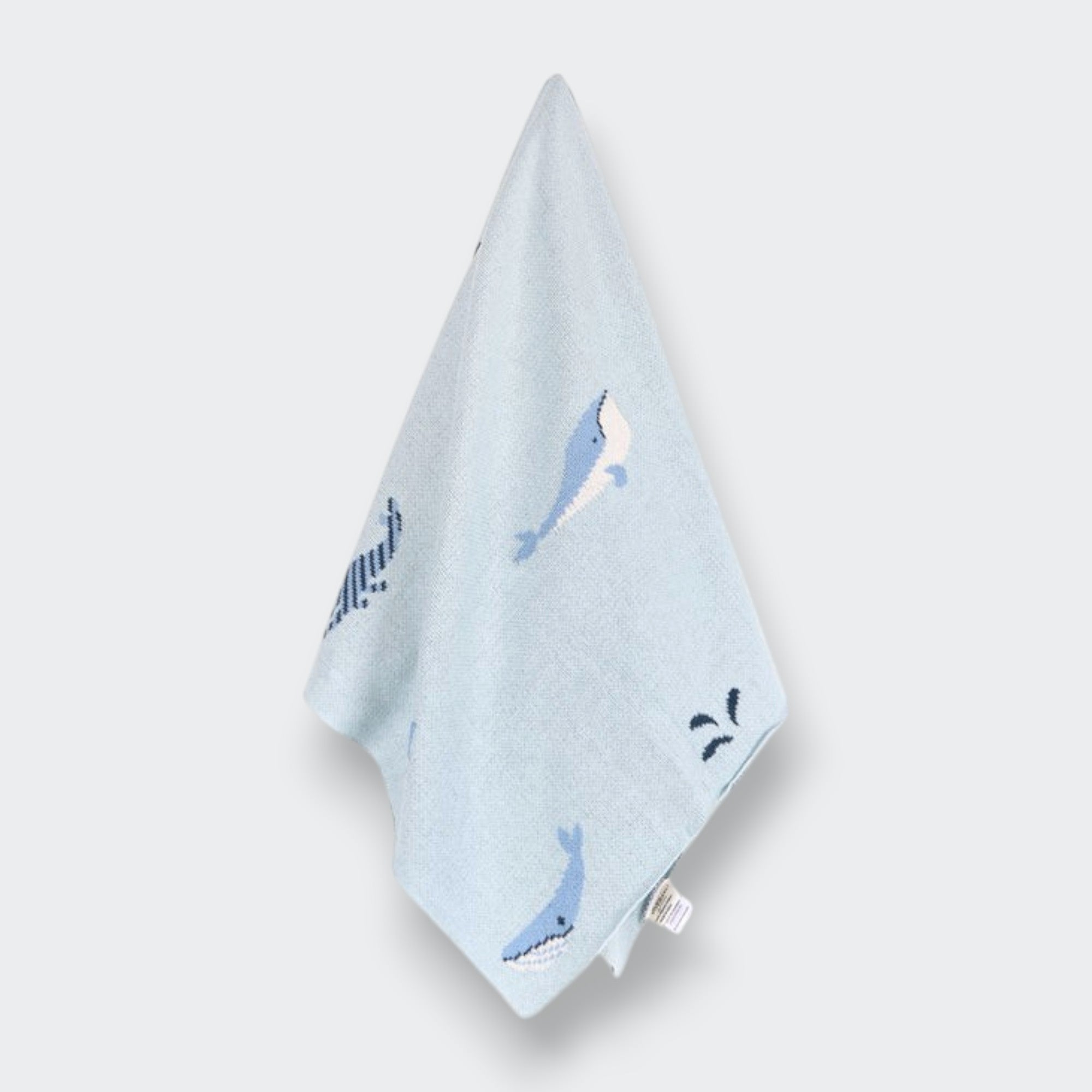 Little Moony Organic knit baby blanket with whale design for babies. Hanging view.