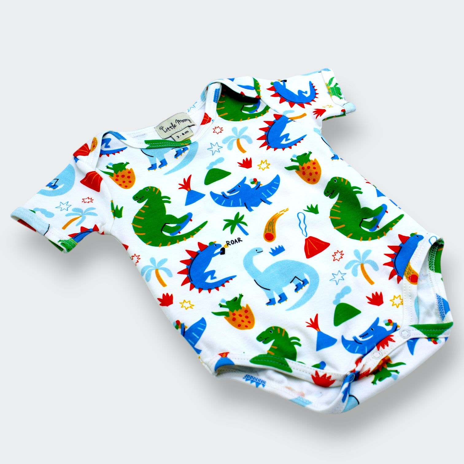 Baby romper with colorful dinosaur pattern on a white background
