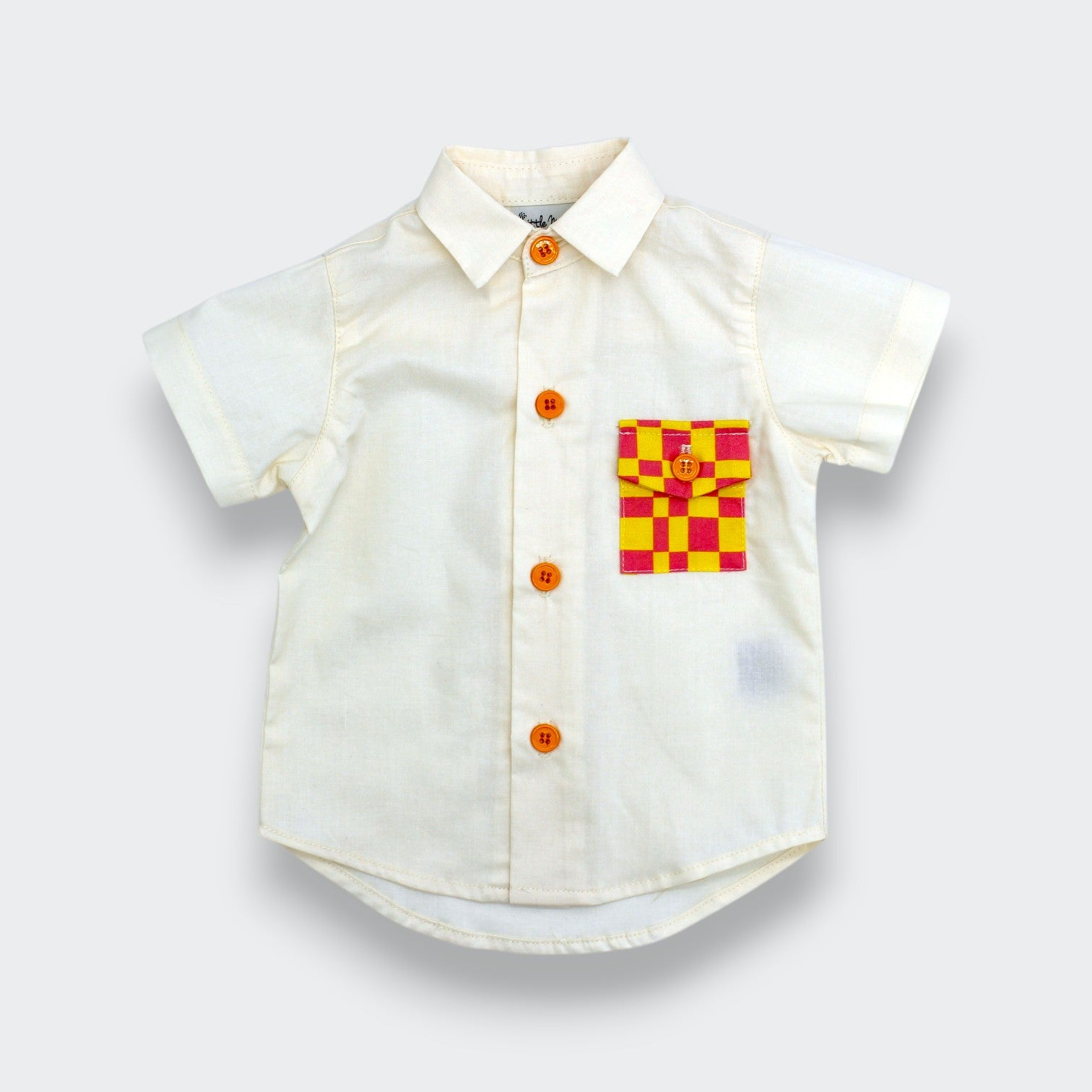 Off white cotton button up shirt for baby and toddler with short sleeves, classic collar, orange buttons, and pink and yellow checkered chest pocket.