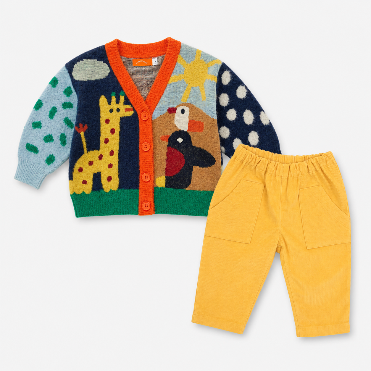 A children's knit cardigan and pants set on a light gray background. The cardigan has a multicolor knitted design with animal and sun motifs, including light blue, navy, orange, green, yellow, and brown.