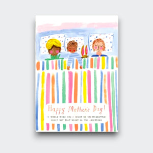 A Mother’s Day card showing a mother asleep in bed between two children under a colorful striped blanket. It reads “Happy Mother’s Day!” with a small message below wishing her uninterrupted sleep.