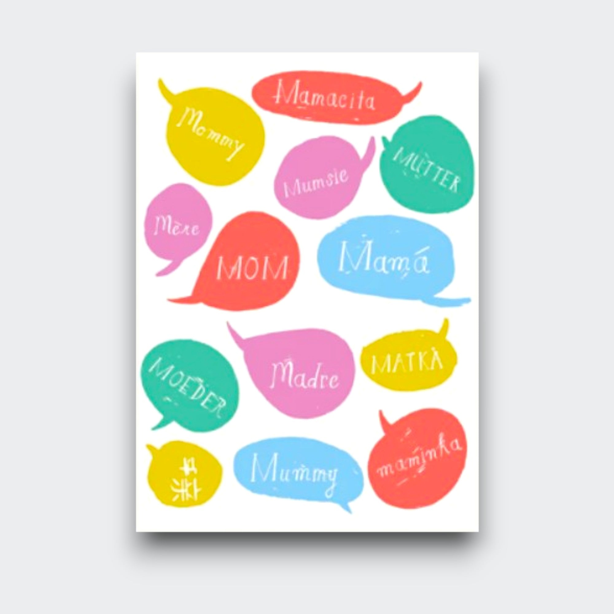 A white greeting card covered in bright speech bubbles, each with a different word for mother, including “Mom,” “Mama,” “Madre,” “Maman,” and “Mamacita.”