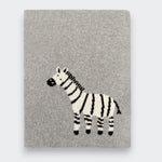 Little Moony folded gray knit baby blanket on a light gray background, with a black-and-white zebra design near the lower center.