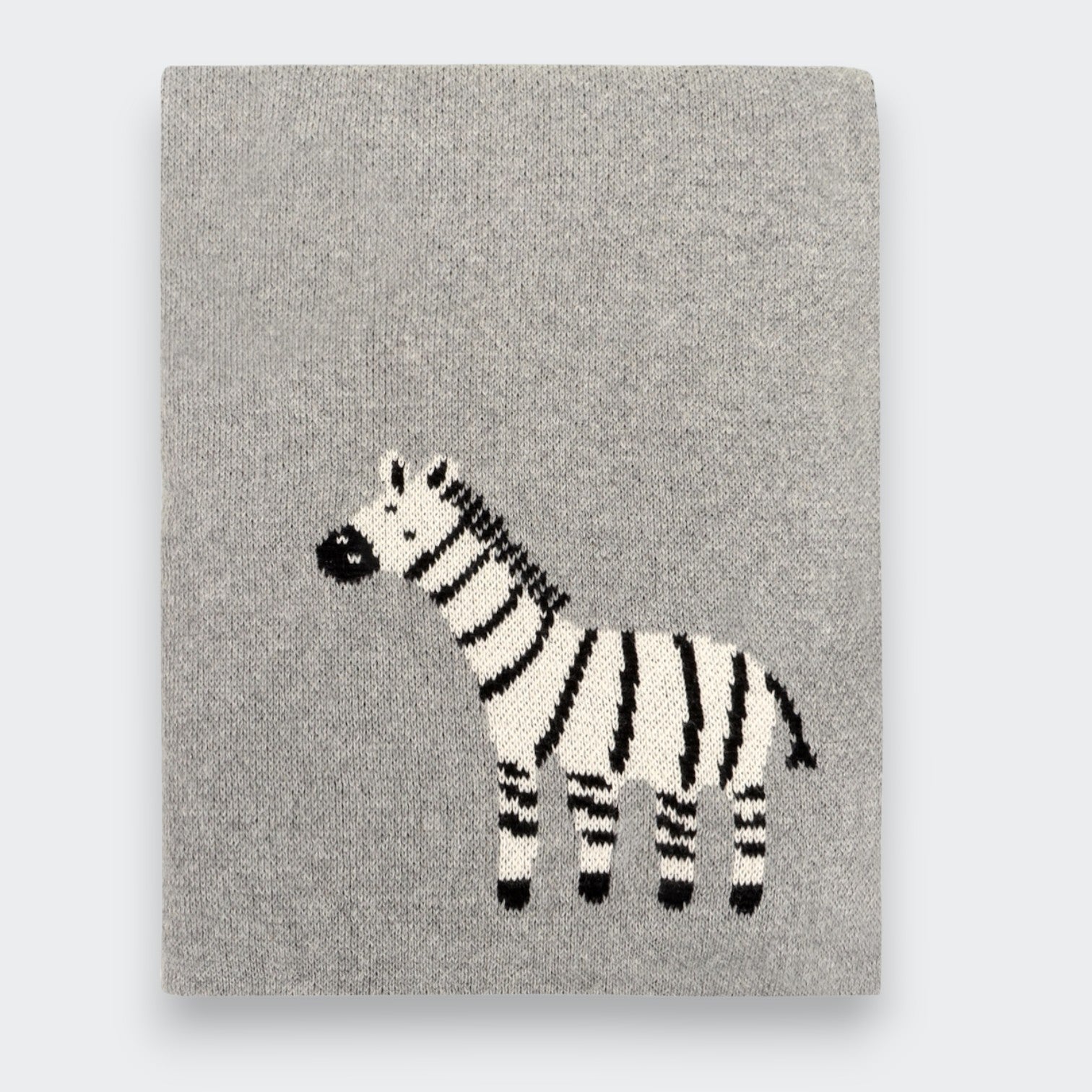 Little Moony folded gray knit baby blanket on a light gray background, with a black-and-white zebra design near the lower center.