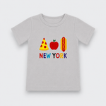 A light gray short-sleeve t-shirt with a colorful graphic on the chest depicting a pizza slice, a red apple, a hot dog, and the text 'NEW YORK' in multicolored letters, shown against a plain light gray background.