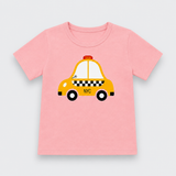 A pink short-sleeve kids' t-shirt featuring a cartoon graphic of a yellow NYC taxi with black and white checkered stripes, displayed on a light gray background.