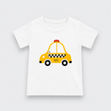 A white short-sleeve baby t-shirt featuring a cartoon graphic of a yellow NYC taxi with black checkered stripes and wheels, displayed on a light gray background.
