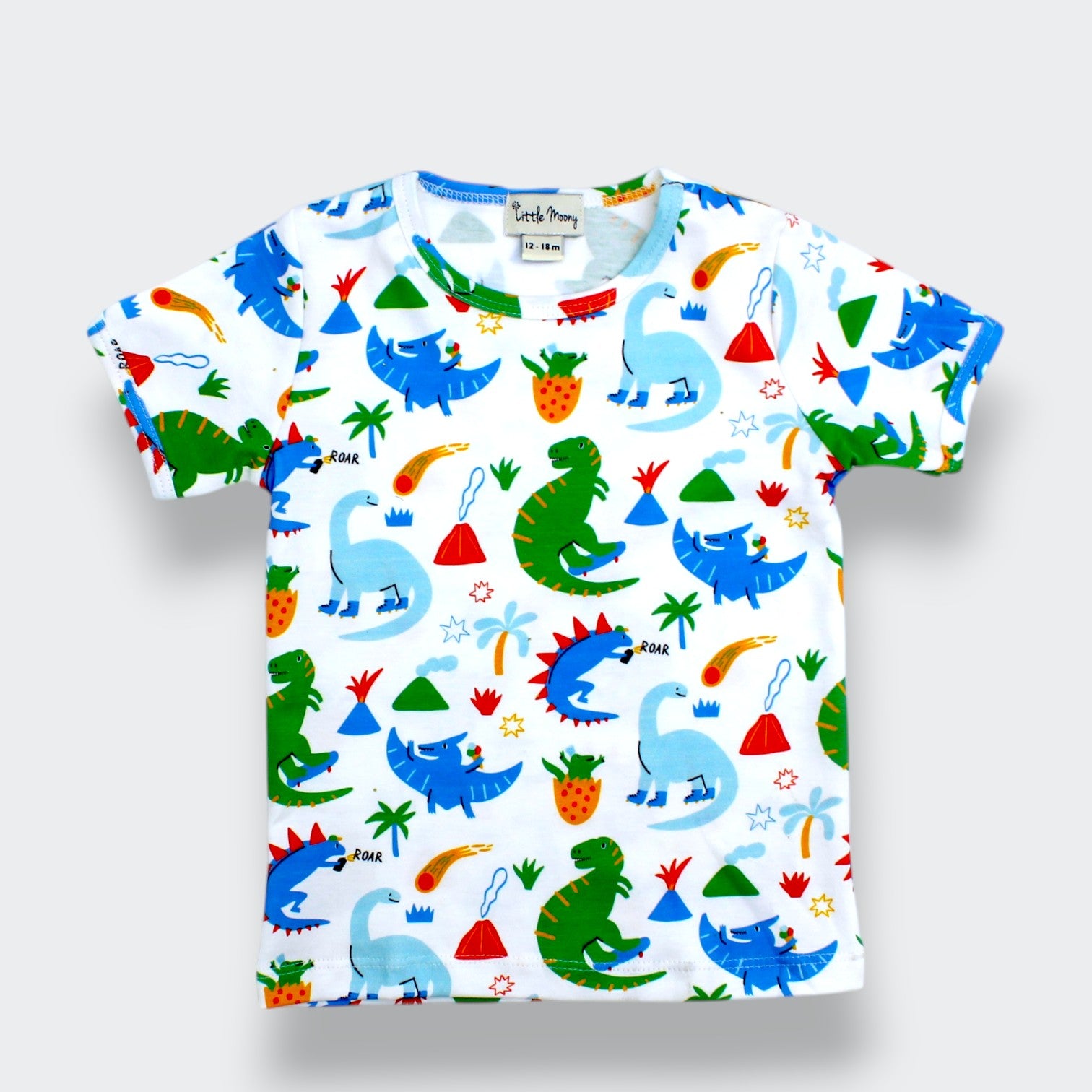 Organic Pima cotton dinosaur T shirt for baby and toddler with colorful dinosaurs, volcanoes, palm trees, strawberries, stars, and comets on white fabric
