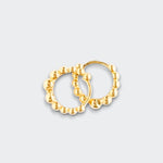 Little Moony Pair of gold hoop earrings on a light gray background